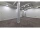 Unfinished basement space featuring modern lighting, neutral walls and flooring, and a support column at 4 Bentley Trace Mnr, Atlanta, GA 30327