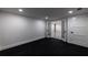 Finished basement with plush dark carpet and an open floor plan, perfect for entertaining guests or relaxing at 4 Bentley Trace Mnr, Atlanta, GA 30327