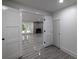 View into the finished basement featuring a stone fireplace and wood-look tile flooring at 4 Bentley Trace Mnr, Atlanta, GA 30327