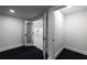 Basement features modern doors, dark carpeting and easy access to other areas of the home at 4 Bentley Trace Mnr, Atlanta, GA 30327
