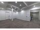 Finished basement featuring modern lighting, neutral walls and flooring, with an open doorway and staircase at 4 Bentley Trace Mnr, Atlanta, GA 30327
