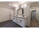 Bathroom boasts a double sink vanity with modern fixtures, tile floors, and neutral paint at 4 Bentley Trace Mnr, Atlanta, GA 30327
