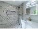 Updated bathroom featuring white marble tile shower, vanity, and modern fixtures at 4 Bentley Trace Mnr, Atlanta, GA 30327