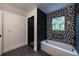 Updated bathroom with a shower and bathtub with elegant black and white tile at 4 Bentley Trace Mnr, Atlanta, GA 30327