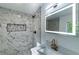 Close-up of luxurious shower with marble tile, dark hardware, and mosaic accents at 4 Bentley Trace Mnr, Atlanta, GA 30327