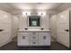 En suite bathroom with double sinks and marble countertops and ample lighting at 4 Bentley Trace Mnr, Atlanta, GA 30327
