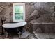 Bathroom featuring a clawfoot soaking tub and marble tiled walls at 4 Bentley Trace Mnr, Atlanta, GA 30327