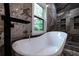 Soaking tub with waterfall faucet and tiled walls at 4 Bentley Trace Mnr, Atlanta, GA 30327