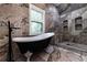 Bright bathroom featuring a soaking tub and marble tiled walls and floors at 4 Bentley Trace Mnr, Atlanta, GA 30327