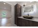 Bathroom vanity with decorative bowl sink, lighted mirror, and wood cabinet at 4 Bentley Trace Mnr, Atlanta, GA 30327