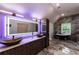 Modern bathroom featuring a double sink vanity, jacuzzi tub, and marble-style tile at 4 Bentley Trace Mnr, Atlanta, GA 30327