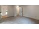 Bright bedroom with carpeted floors and hallway access via modern, paneled doors at 4 Bentley Trace Mnr, Atlanta, GA 30327