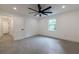 A bright carpeted bedroom boasts a modern fan, window view, and easy hallway access at 4 Bentley Trace Mnr, Atlanta, GA 30327