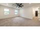 Spacious bedroom with ceiling fan, two windows, and attached bathroom at 4 Bentley Trace Mnr, Atlanta, GA 30327