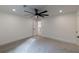 A carpeted bedroom features a contemporary ceiling fan and doorways for easy access at 4 Bentley Trace Mnr, Atlanta, GA 30327