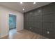 The empty room features a grid-patterned dark wall and light hardwood flooring at 4 Bentley Trace Mnr, Atlanta, GA 30327