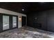 This outdoor covered patio features dark wood ceilings and stone flooring at 4 Bentley Trace Mnr, Atlanta, GA 30327