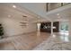 Open-concept dining and living area with elegant lighting, seamlessly connected to a modern kitchen at 4 Bentley Trace Mnr, Atlanta, GA 30327