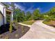 Landscaped front yard with walkway and circular drive to the stunning white brick home at 4 Bentley Trace Mnr, Atlanta, GA 30327