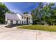 Front exterior of home featuring a circular drive, manicured lawn, and landscaped entrance at 4 Bentley Trace Mnr, Atlanta, GA 30327