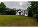 Exterior view of white brick house surrounded by trees at 4 Bentley Trace Mnr, Atlanta, GA 30327
