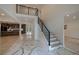 Welcoming foyer showcasing modern staircase railings and an entryway to a stylish kitchen and dining area at 4 Bentley Trace Mnr, Atlanta, GA 30327