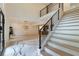 Grand foyer with a staircase featuring modern railings, and an entryway door leading to the dining area at 4 Bentley Trace Mnr, Atlanta, GA 30327