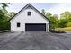 Exterior view of detached garage with black garage door, and fresh landscaping at 4 Bentley Trace Mnr, Atlanta, GA 30327
