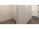 Neutral hallway leads to the closet, and features light walls, and tile flooring at 4 Bentley Trace Mnr, Atlanta, GA 30327