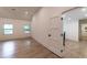 Hallway view with hardwood floors, base trim, and views to the outside at 4 Bentley Trace Mnr, Atlanta, GA 30327