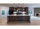 Spacious kitchen features an island with eat in seating and stainless appliances, as well as view to the living area at 4 Bentley Trace Mnr, Atlanta, GA 30327