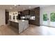 Modern kitchen featuring a waterfall island, stainless steel appliances, and custom cabinetry at 4 Bentley Trace Mnr, Atlanta, GA 30327