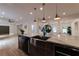 Kitchen island with stainless steel sink, modern faucet and view of living spaces at 4 Bentley Trace Mnr, Atlanta, GA 30327