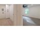 A hallway view leads to a laundry room with white cabinets and a bedroom with wooded views at 4 Bentley Trace Mnr, Atlanta, GA 30327