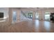 Open living space with large windows and wood floors, connected to the foyer with sleek black trim at 4 Bentley Trace Mnr, Atlanta, GA 30327