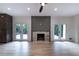 Spacious living room featuring a cozy fireplace and doors to the outdoor deck at 4 Bentley Trace Mnr, Atlanta, GA 30327