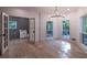 Open living room with chandelier, hardwood floors, and three large windows at 4 Bentley Trace Mnr, Atlanta, GA 30327