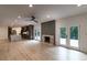 Open-concept living space boasts hardwood floors, fireplace, access to backyard deck and view of kitchen at 4 Bentley Trace Mnr, Atlanta, GA 30327