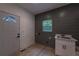 Mudroom with utility sink, exterior door and grey accent wall at 4 Bentley Trace Mnr, Atlanta, GA 30327