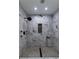 Updated shower with elegant marble tile surround, black fixtures, and mosaic floor at 4 Bentley Trace Mnr, Atlanta, GA 30327