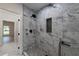 Modern walk-in shower with marble tile surround and matte black fixtures at 4 Bentley Trace Mnr, Atlanta, GA 30327