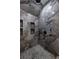 Shower with marble tiled walls, rain shower head, and built in shelves at 4 Bentley Trace Mnr, Atlanta, GA 30327