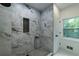 Modern shower with floor-to-ceiling marble tile and black fixtures at 4 Bentley Trace Mnr, Atlanta, GA 30327