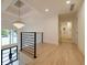 Bright upstairs landing with hardwood floors and modern chandelier at 4 Bentley Trace Mnr, Atlanta, GA 30327