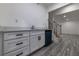 A bright bar area with white cabinets, black hardware, and wood-style flooring at 4 Bentley Trace Mnr, Atlanta, GA 30327