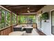 Covered back porch offering outdoor seating, a fan, and views of the landscaped backyard at 4771 Pinefield Nw Dr, Acworth, GA 30102