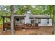 Backyard view of home with wooden deck, covered porch, and backyard at 4771 Pinefield Nw Dr, Acworth, GA 30102