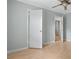 This bedroom has light wood laminate flooring, with pale green walls and bright white trim at 4771 Pinefield Nw Dr, Acworth, GA 30102