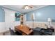 Bedroom featuring blue walls, white trim and a wooden desk with modern fixtures at 4771 Pinefield Nw Dr, Acworth, GA 30102