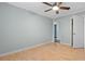 This bedroom features bright white trim, pale green walls, wood laminate flooring, and a ceiling fan at 4771 Pinefield Nw Dr, Acworth, GA 30102